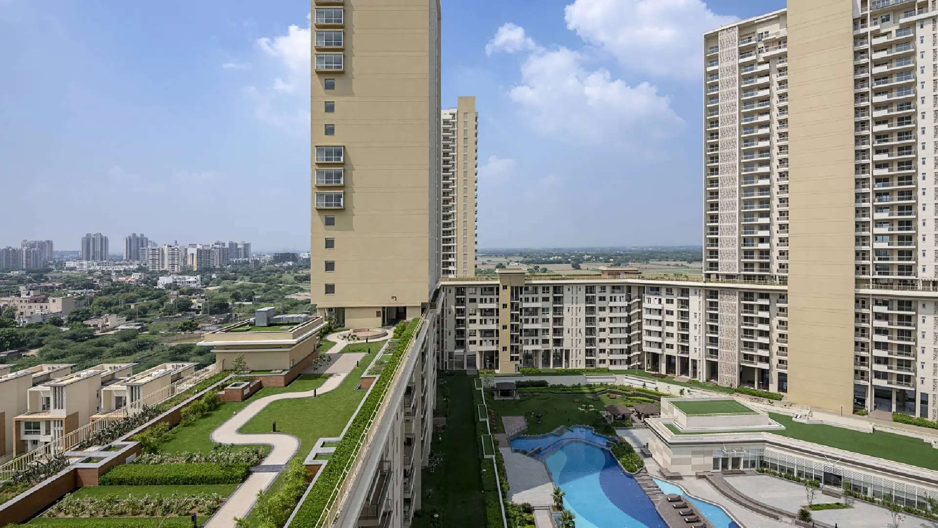 Experion Windchants luxury apartments in Sector 112 Gurugram with swimming pool and landscaped gardens aerial view