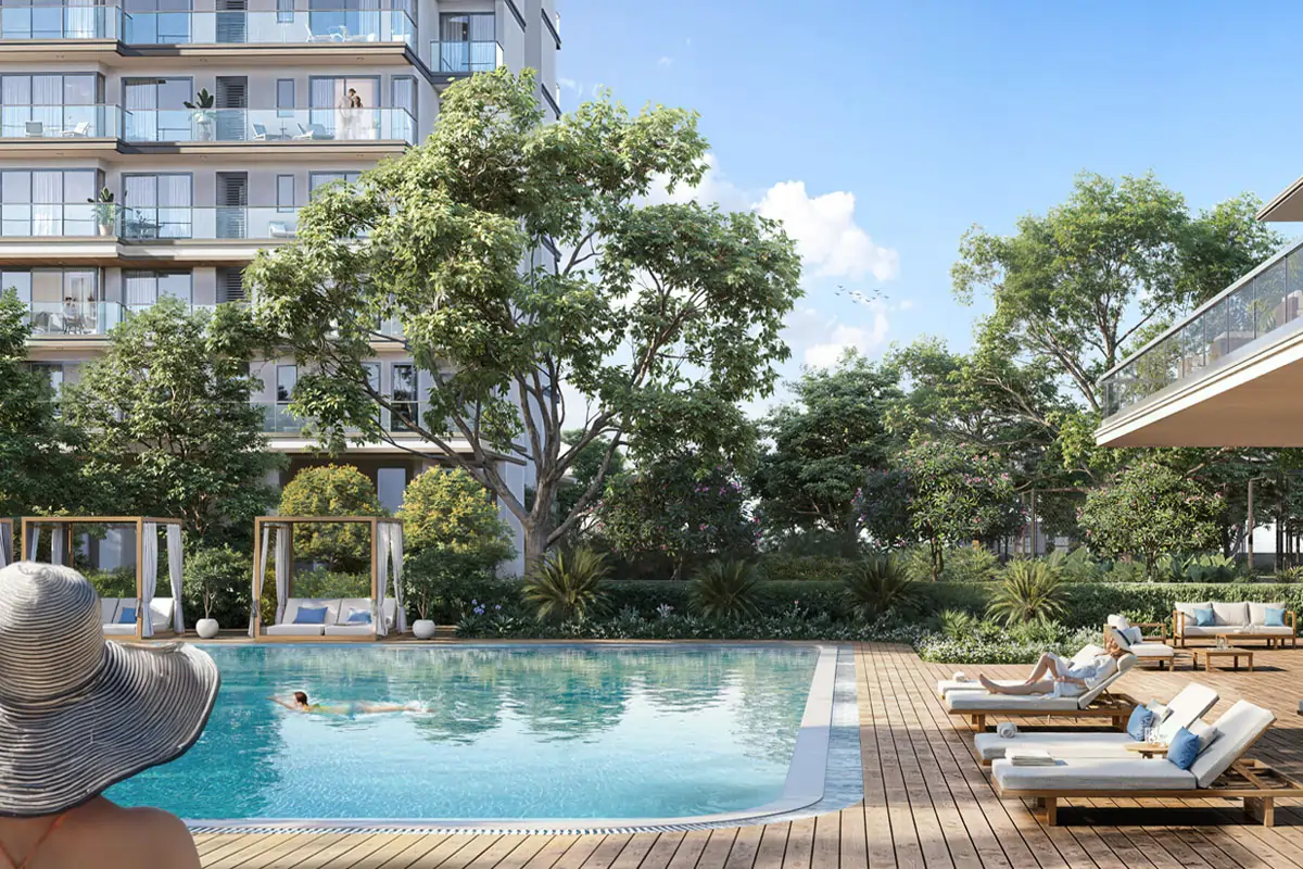 Emaar Serenity Hills Sector 86 New Gurgaon luxury swimming pool with wooden deck, premium lounge chairs, modern cabanas, and tranquil water features surrounded by mature trees and residential towers